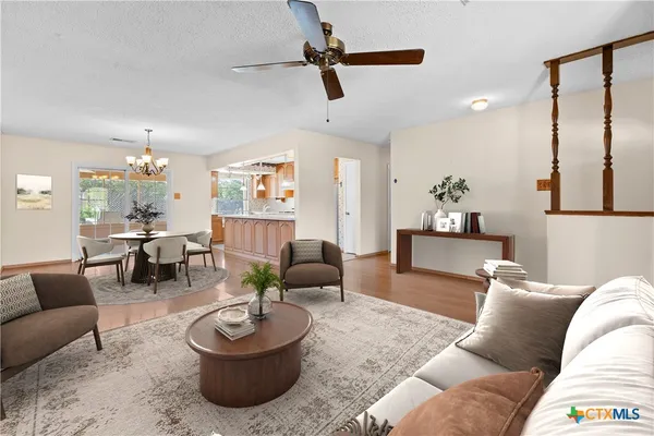 a living room with furniture and a chandelier