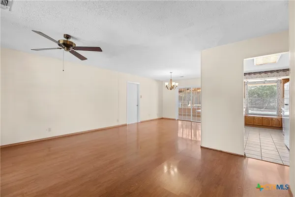 a view of a room with wooden floor and a window