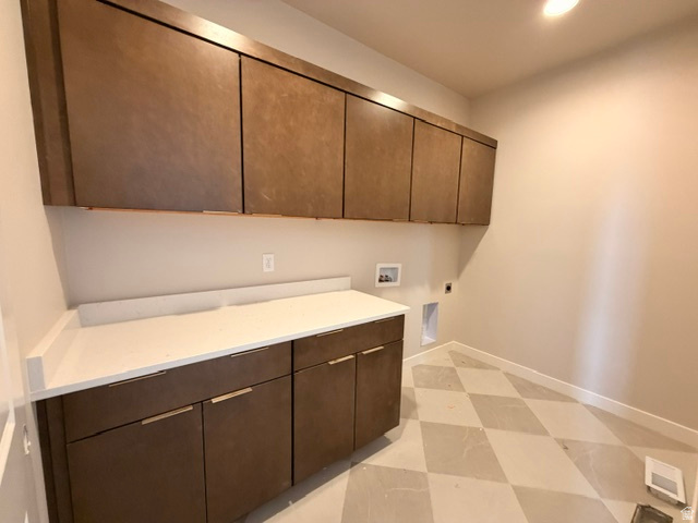 5885 Canyon Rim Road, Unit 624 Lehi, UT 84048 - Photo 5 of 10 Laundry room featuring extensive cabinetry, white countertop, and diamond-patterned flooring