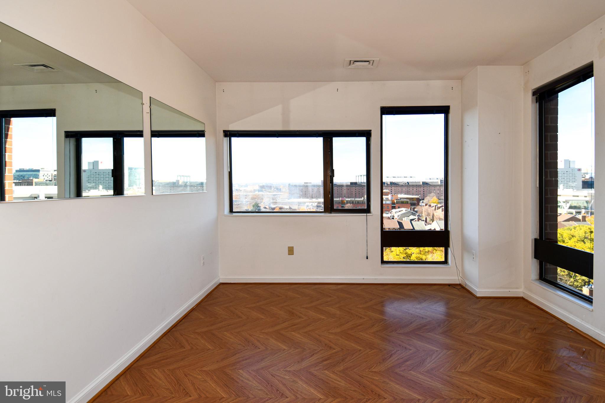 10 East Lee Street, Unit 809 Baltimore, MD 21202 - Photo 21 of 58 an empty room with windows and natural light