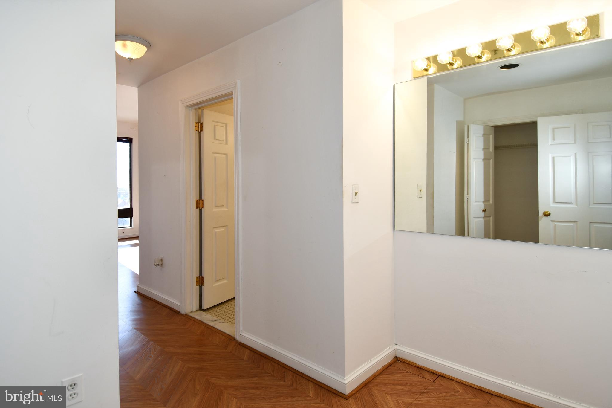 10 East Lee Street, Unit 809 Baltimore, MD 21202 - Photo 27 of 58 a view of a hallway with wooden floor