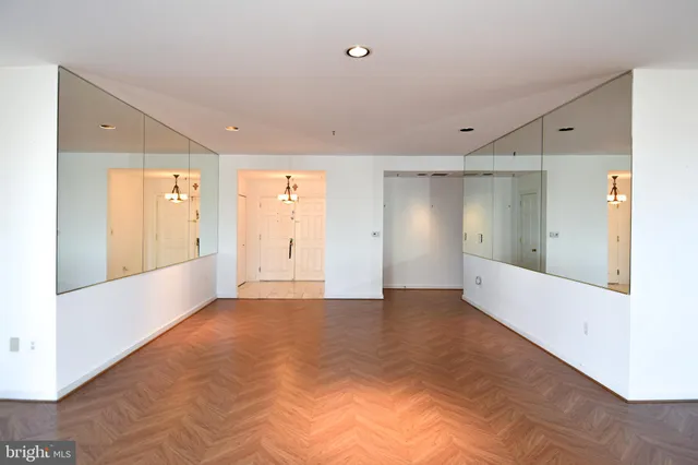 a large kitchen with stainless steel appliances kitchen island granite countertop a refrigerator and a stove top oven