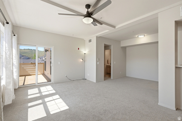 900 Bitner Road, Unit P20 Park City, UT 84098 - Photo 6 of 42 Spacious carpeted interior featuring a ceiling fan, sliding glass doors to a private balcony, and recessed lighting