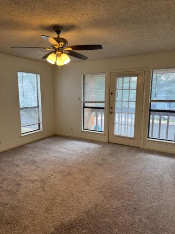 8333 Fathom Circle, Unit B Austin, TX 78750 - Photo 11 of 21 Unfurnished room with a textured ceiling, carpet floors, and ceiling fan