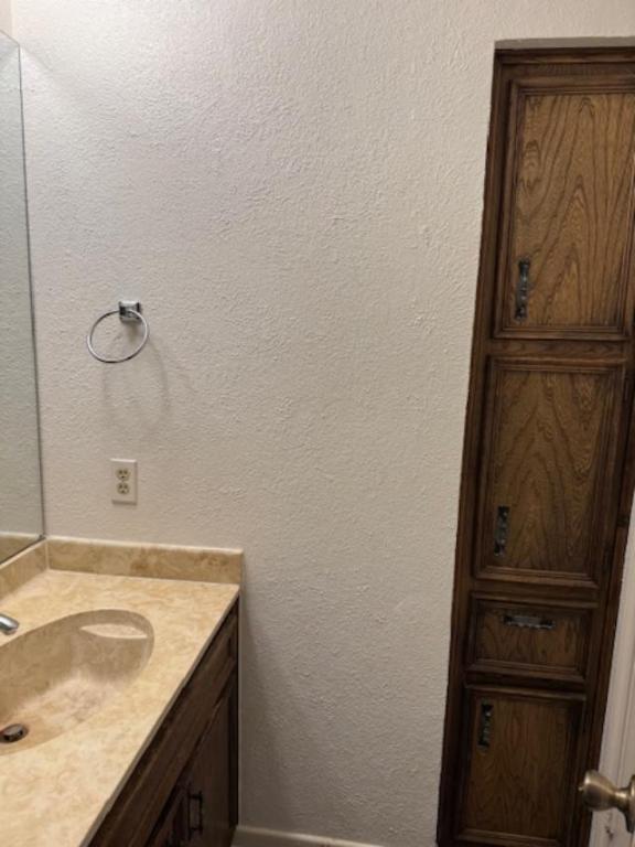 8333 Fathom Circle, Unit B Austin, TX 78750 - Photo 14 of 21 Bathroom featuring a textured wall and vanity