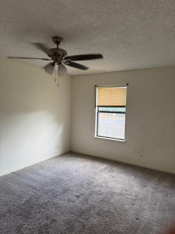 8333 Fathom Circle, Unit B Austin, TX 78750 - Photo 3 of 21 Spare room with a textured ceiling, carpet, and a ceiling fan