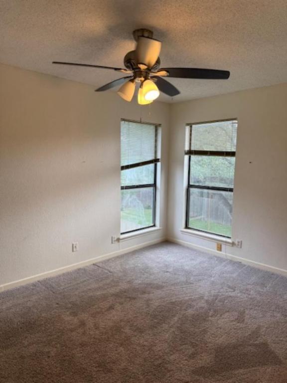 8333 Fathom Circle, Unit B Austin, TX 78750 - Photo 4 of 21 Carpeted empty room with a textured ceiling and a ceiling fan