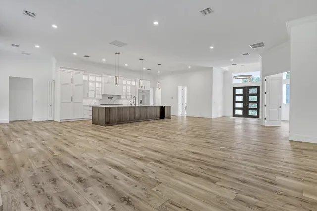 an empty room with wooden floor and a window