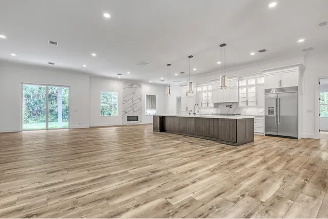 a view of a room with a ceiling fan and window