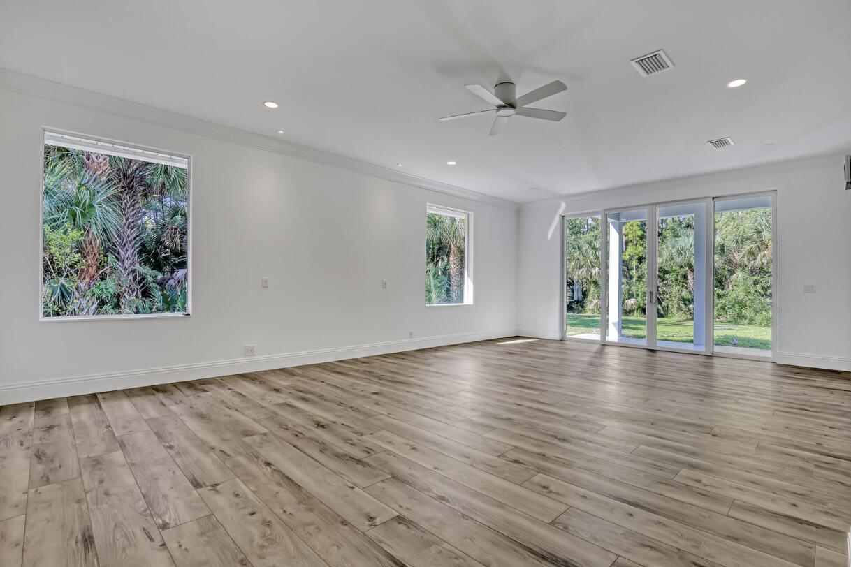 11871 Randolph Siding Road Jupiter, FL 33478 - Photo 27 of 51 a view of an empty room with wooden floor and a window