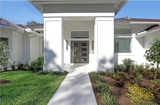 a view of a livingroom with a flat screen tv wooden floor and window