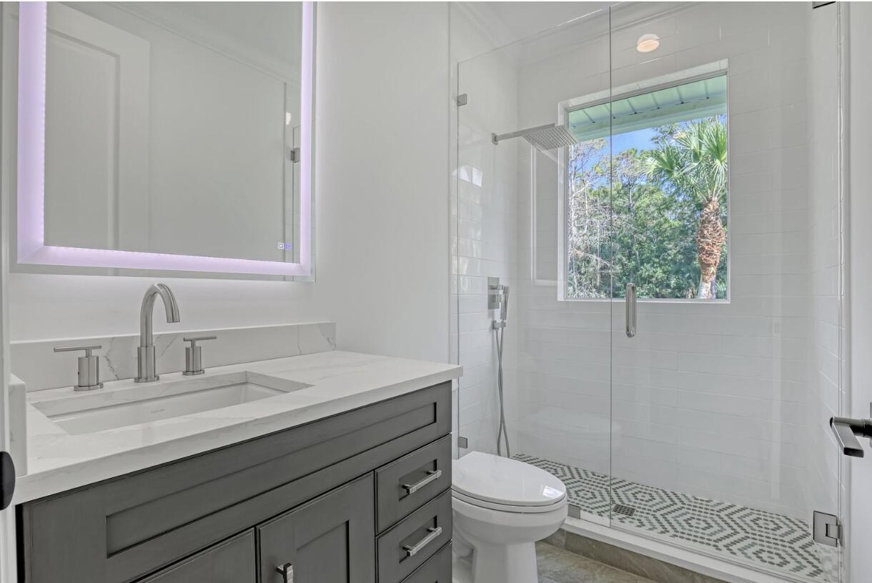 11871 Randolph Siding Road Jupiter, FL 33478 - Photo 44 of 51 a bathroom with a sink toilet and shower