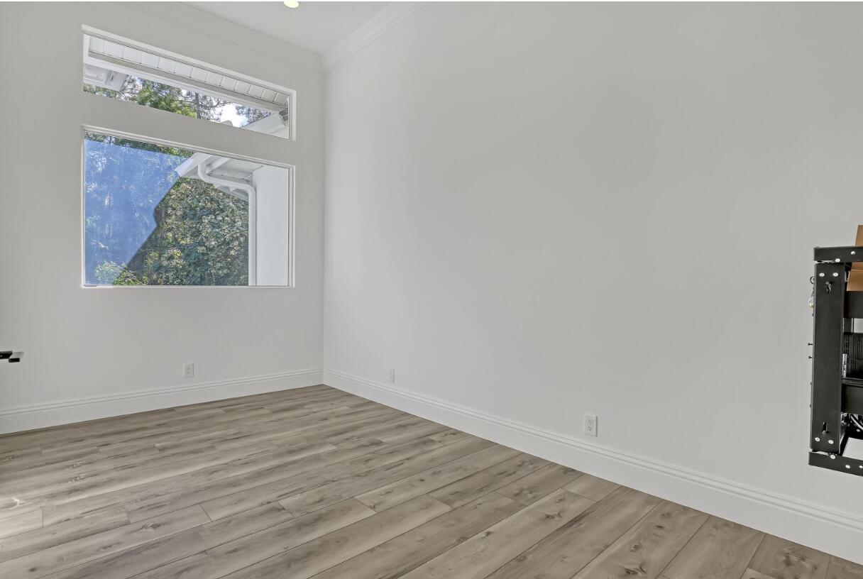 11871 Randolph Siding Road Jupiter, FL 33478 - Photo 47 of 51 an empty room with wooden floor and a window