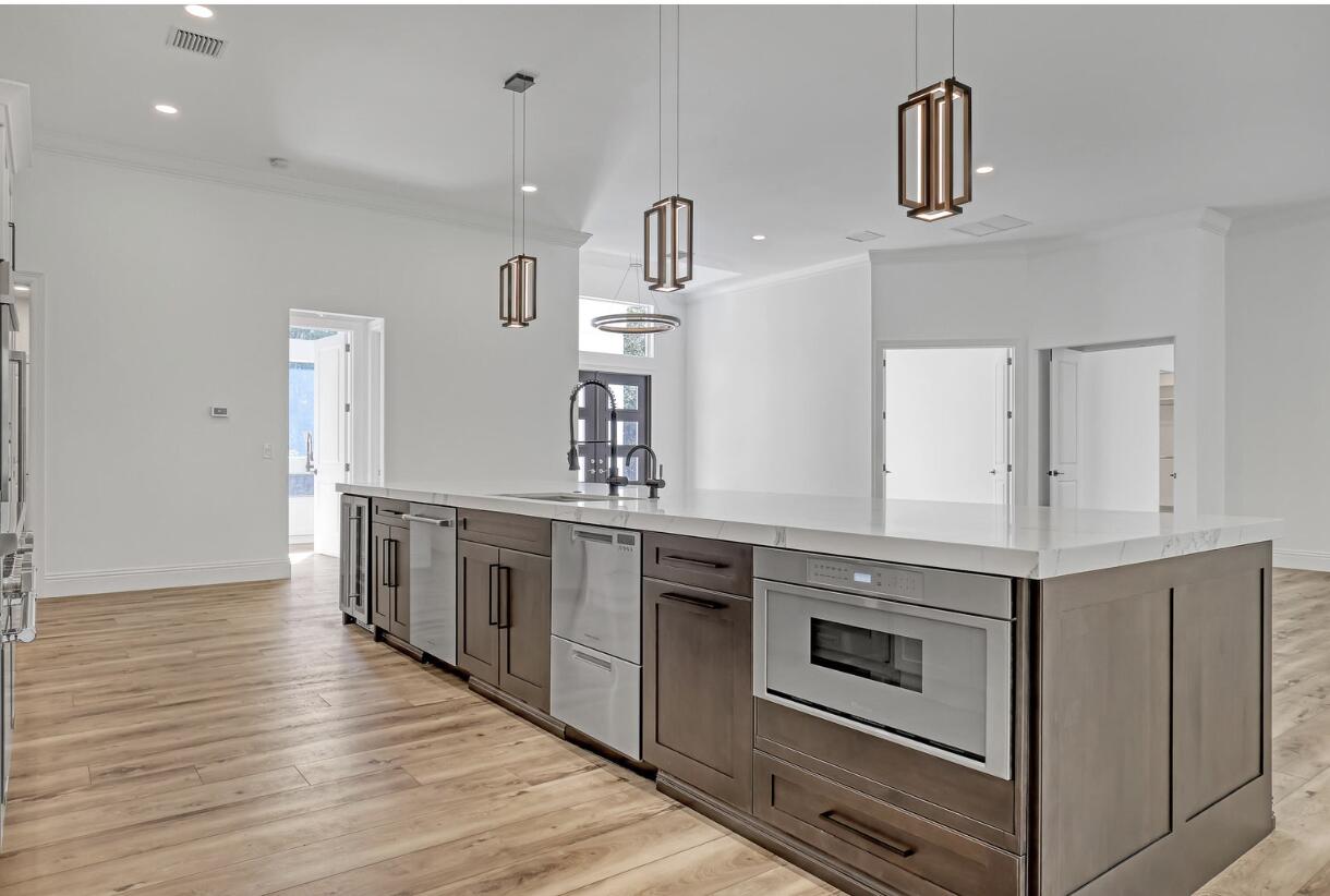 11871 Randolph Siding Road Jupiter, FL 33478 - Photo 8 of 51 a kitchen with stainless steel appliances granite countertop a stove and a sink