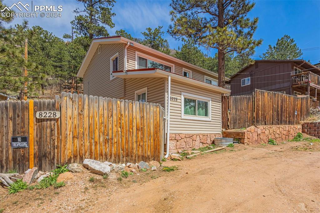 8228 Highway 24 Cascade, CO 80809 - Photo 17 of 34 a front view of a house with a yard