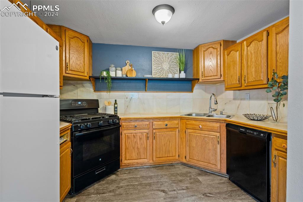 8228 Highway 24 Cascade, CO 80809 - Photo 7 of 34 a kitchen with stainless steel appliances granite countertop a stove sink and cabinets