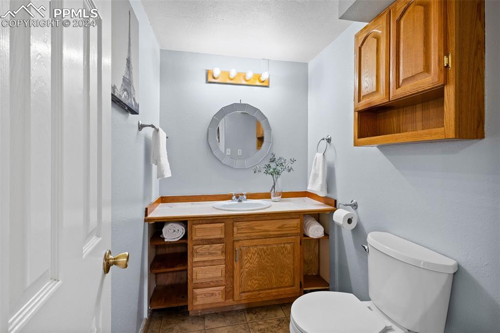 8228 Highway 24 Cascade, CO 80809 - Photo 8 of 34 a bathroom with a toilet a sink and a mirror