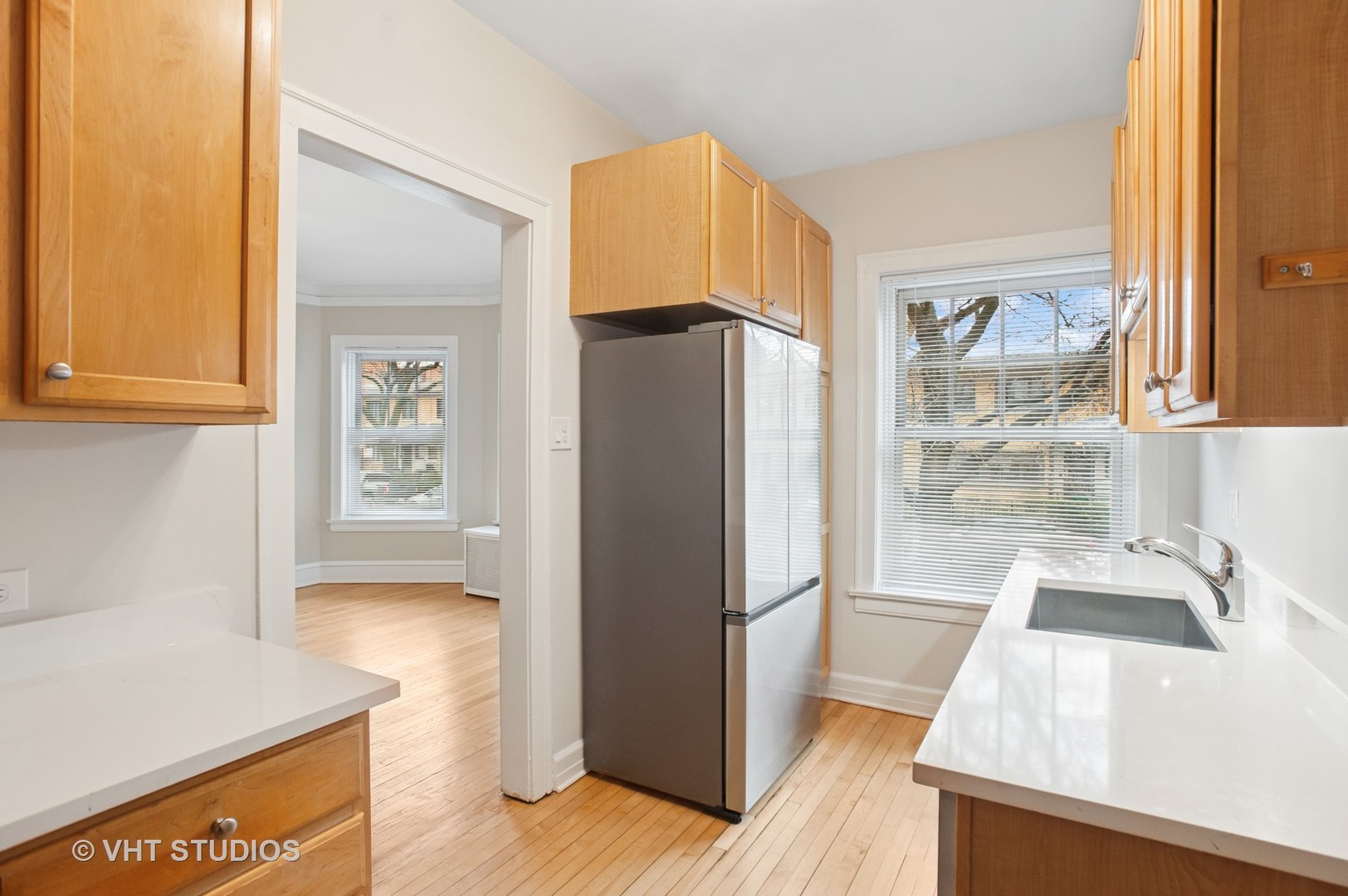 550 West Brompton Avenue, Unit 1S Chicago, IL 60657 - Photo 12 of 28 a view of a kitchen with wooden floor and a refrigerator