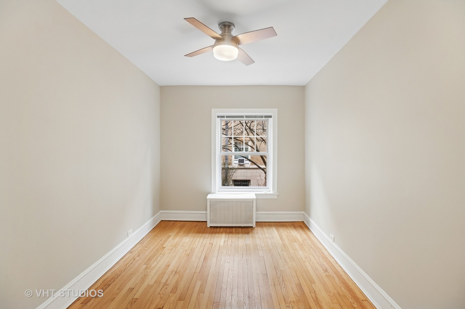 550 West Brompton Avenue, Unit 1S Chicago, IL 60657 - Photo 15 of 28 an empty room with wooden floor and windows