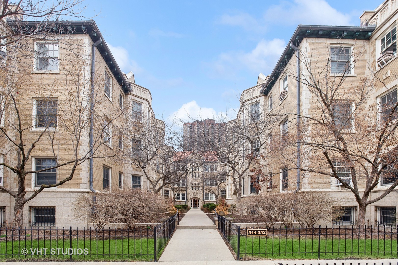 550 West Brompton Avenue, Unit 1S Chicago, IL 60657 - Photo 2 of 28 a view of a white house with a yard