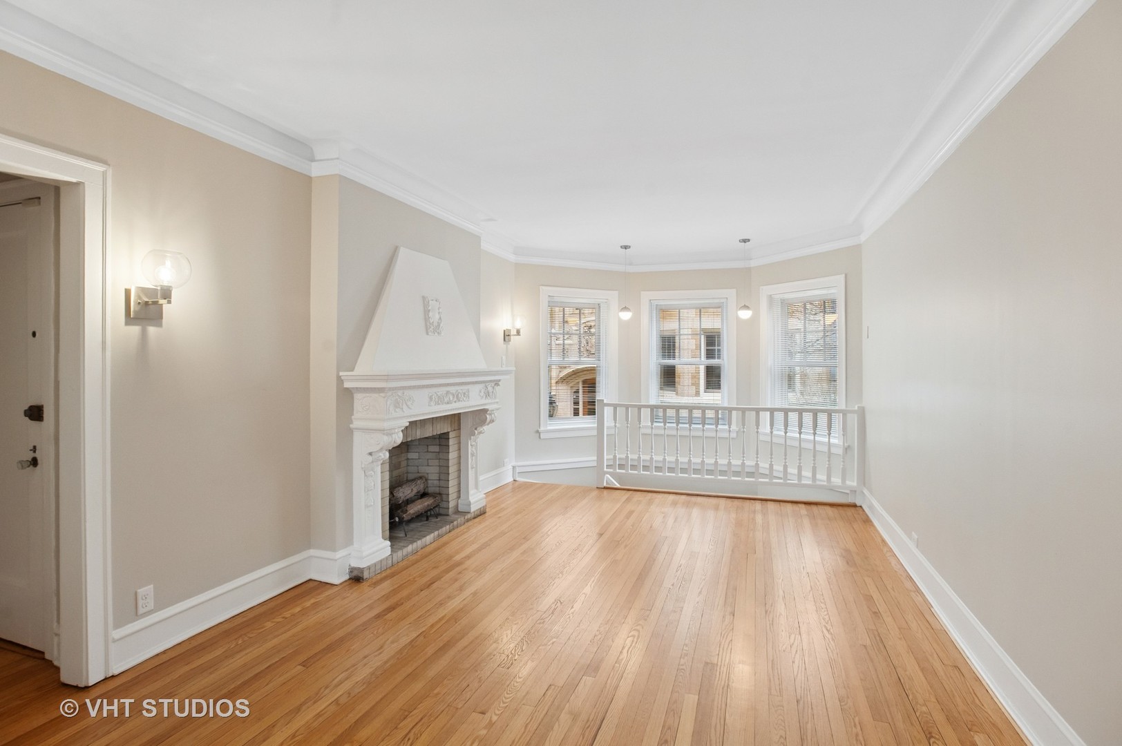 550 West Brompton Avenue, Unit 1S Chicago, IL 60657 - Photo 4 of 28 a view of an empty room with wooden floor fireplace and a window