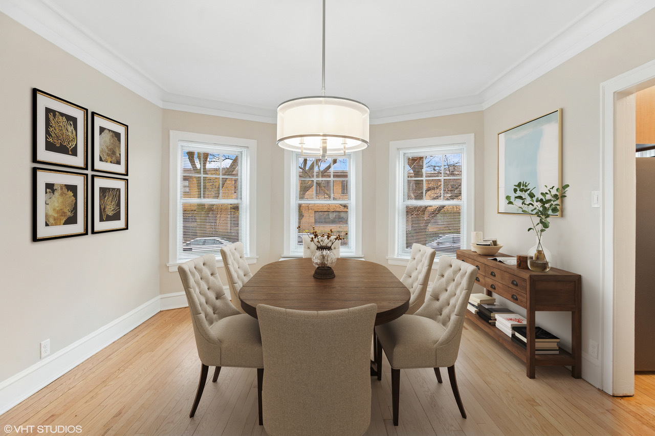 550 West Brompton Avenue, Unit 1S Chicago, IL 60657 - Photo 8 of 28 a dining room with furniture potted plants and wooden floor