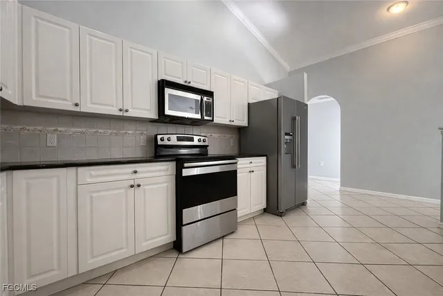 a kitchen with stainless steel appliances granite countertop a refrigerator sink and cabinets