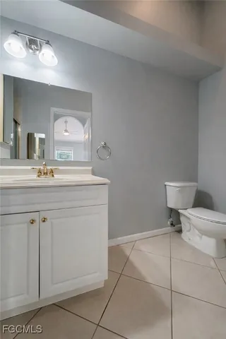 a bathroom with a sink vanity and toilet