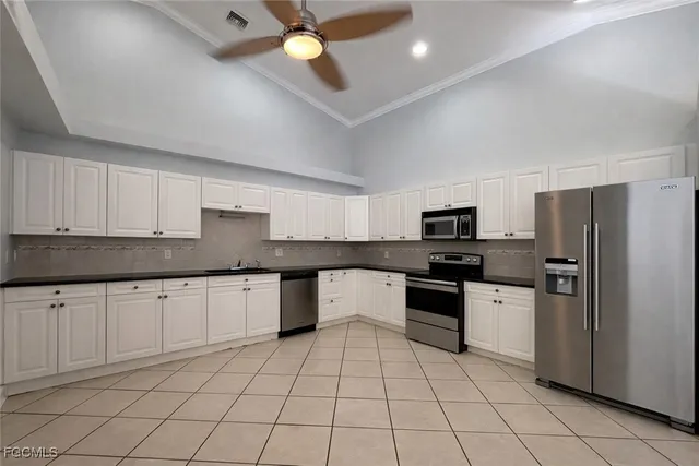a kitchen with stainless steel appliances granite countertop a sink and stove top oven