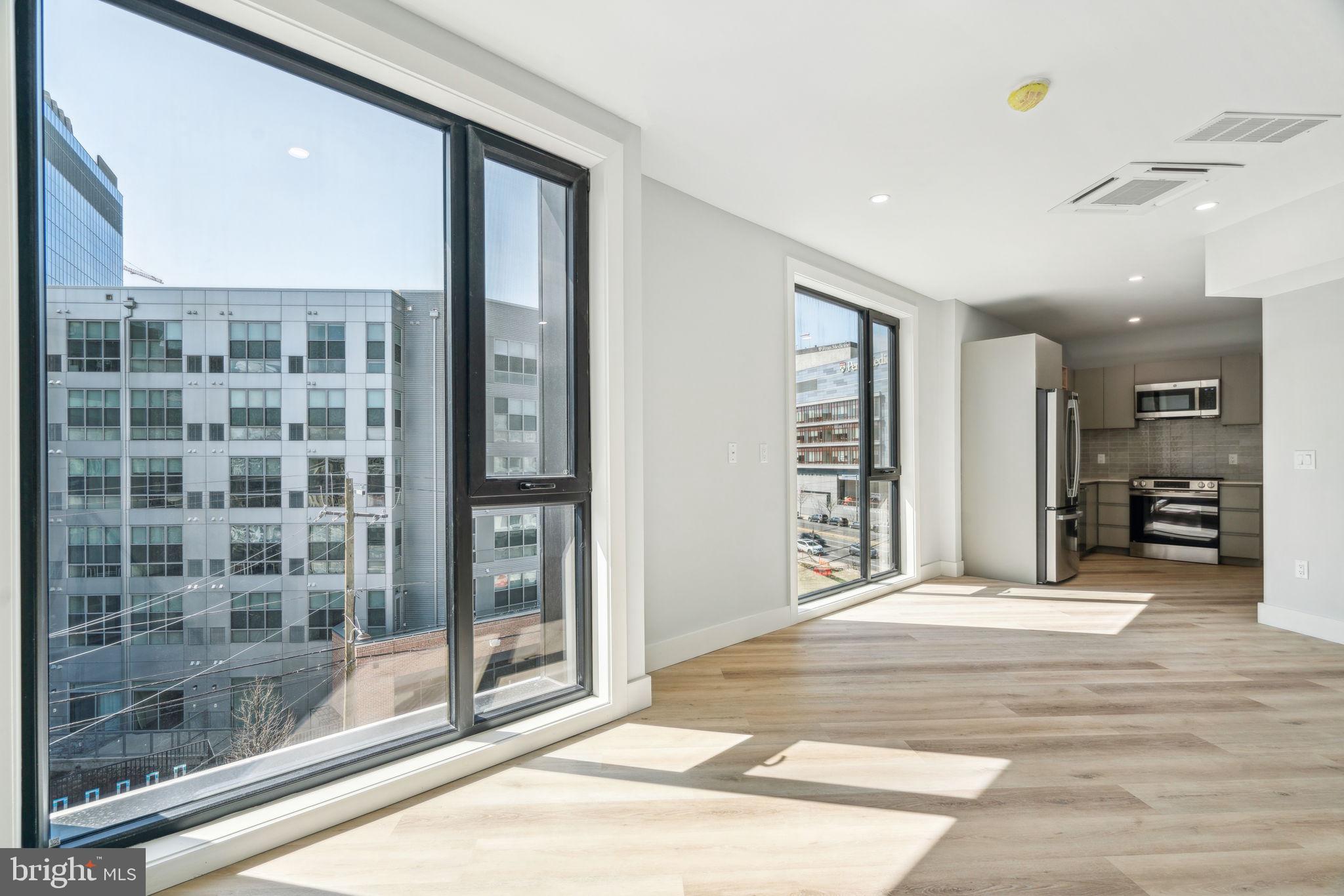 3748-9 Lancaster Avenue, Unit 211 Philadelphia, PA 19104 - Photo 16 of 29 a view of a big room with windows and entryway