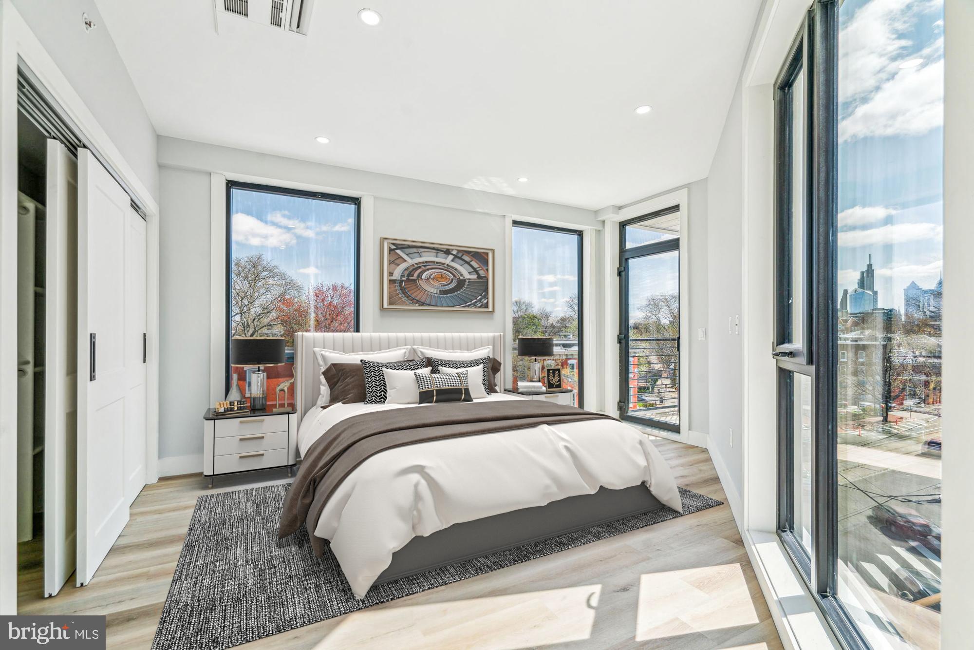 3748-9 Lancaster Avenue, Unit 211 Philadelphia, PA 19104 - Photo 23 of 29 a bedroom with a large bed and a large window