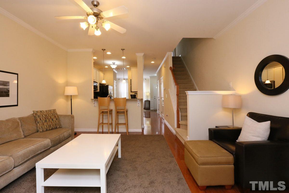 226 Cedar Elm Road Durham, NC 27713 - Photo 11 of 25 a living room with furniture and a chandelier