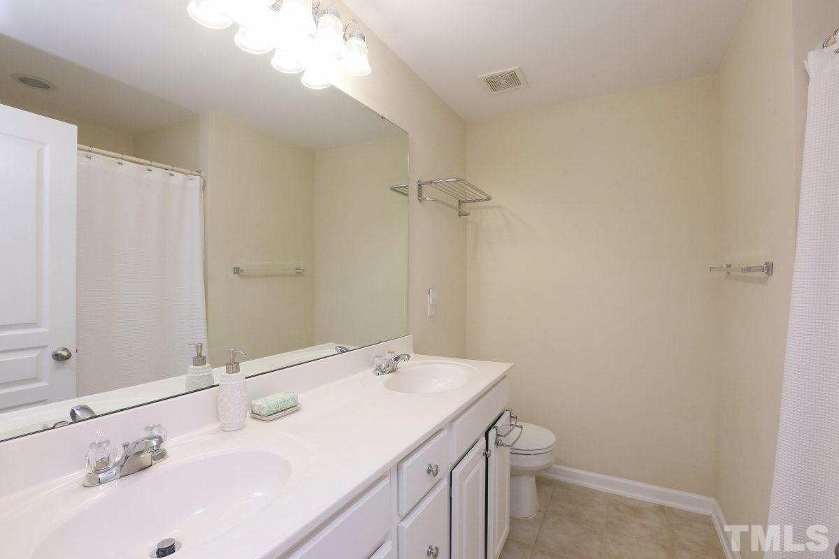 226 Cedar Elm Road Durham, NC 27713 - Photo 15 of 25 a bathroom with a sink toilet and a mirror