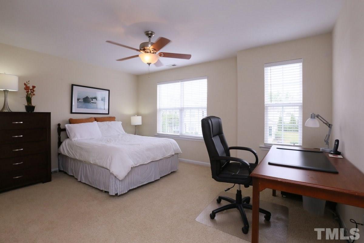 226 Cedar Elm Road Durham, NC 27713 - Photo 16 of 25 a bedroom with a large bed and a desk