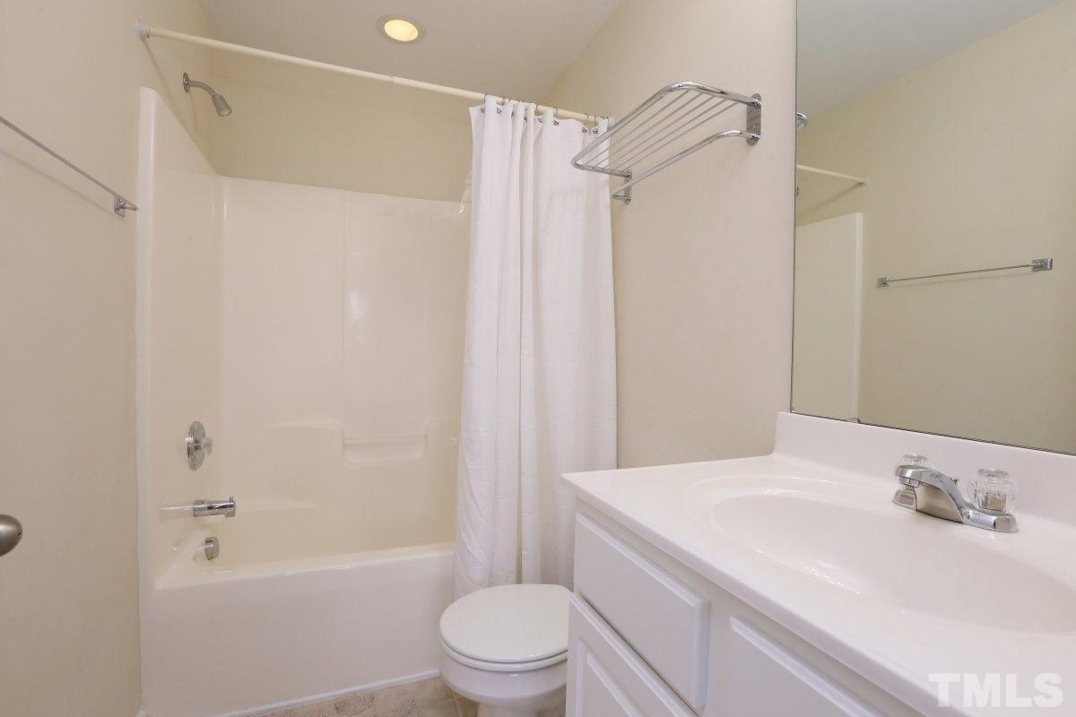 226 Cedar Elm Road Durham, NC 27713 - Photo 17 of 25 a bathroom with a sink a toilet and shower