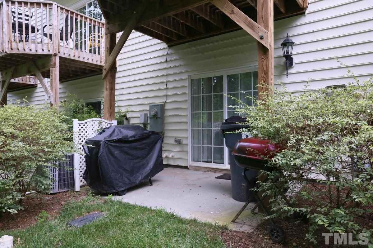 226 Cedar Elm Road Durham, NC 27713 - Photo 24 of 25 a view of a chair and table in backyard of the house