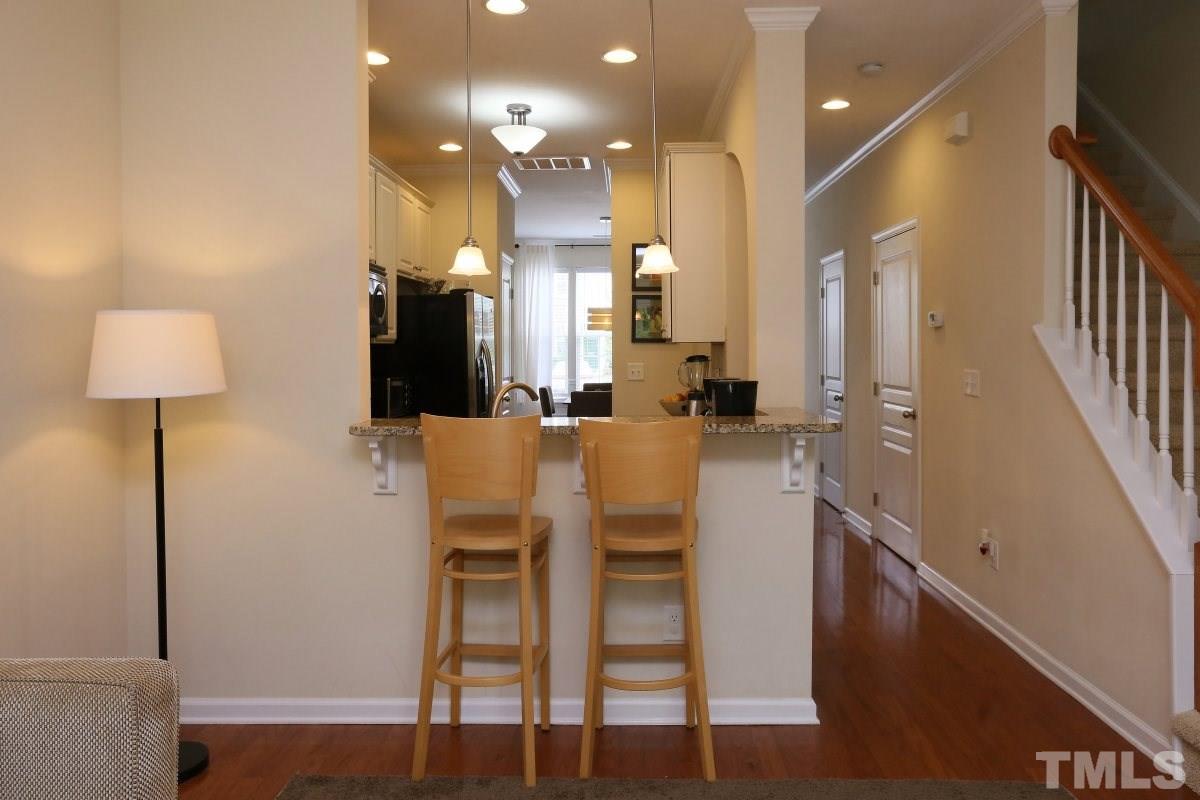 226 Cedar Elm Road Durham, NC 27713 - Photo 9 of 25 a dining room with furniture and a chandelier