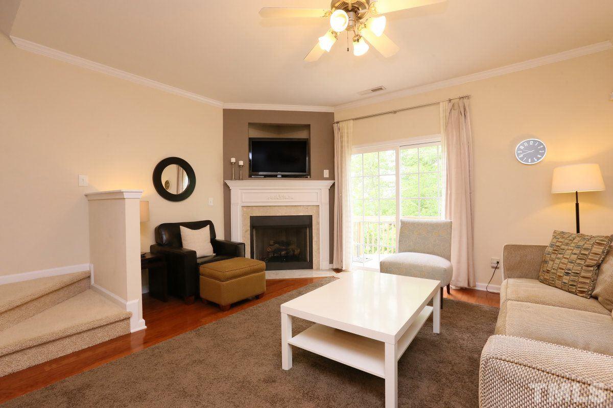 226 Cedar Elm Road Durham, NC 27713 - Photo 10 of 25 a living room with furniture a fireplace and a flat screen tv