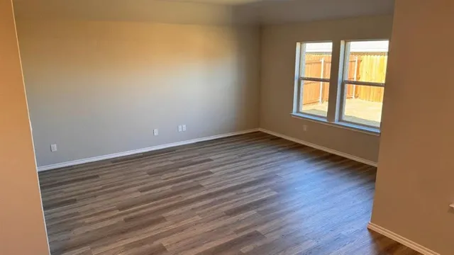 a kitchen with kitchen island stainless steel appliances a sink cabinets and wooden floor