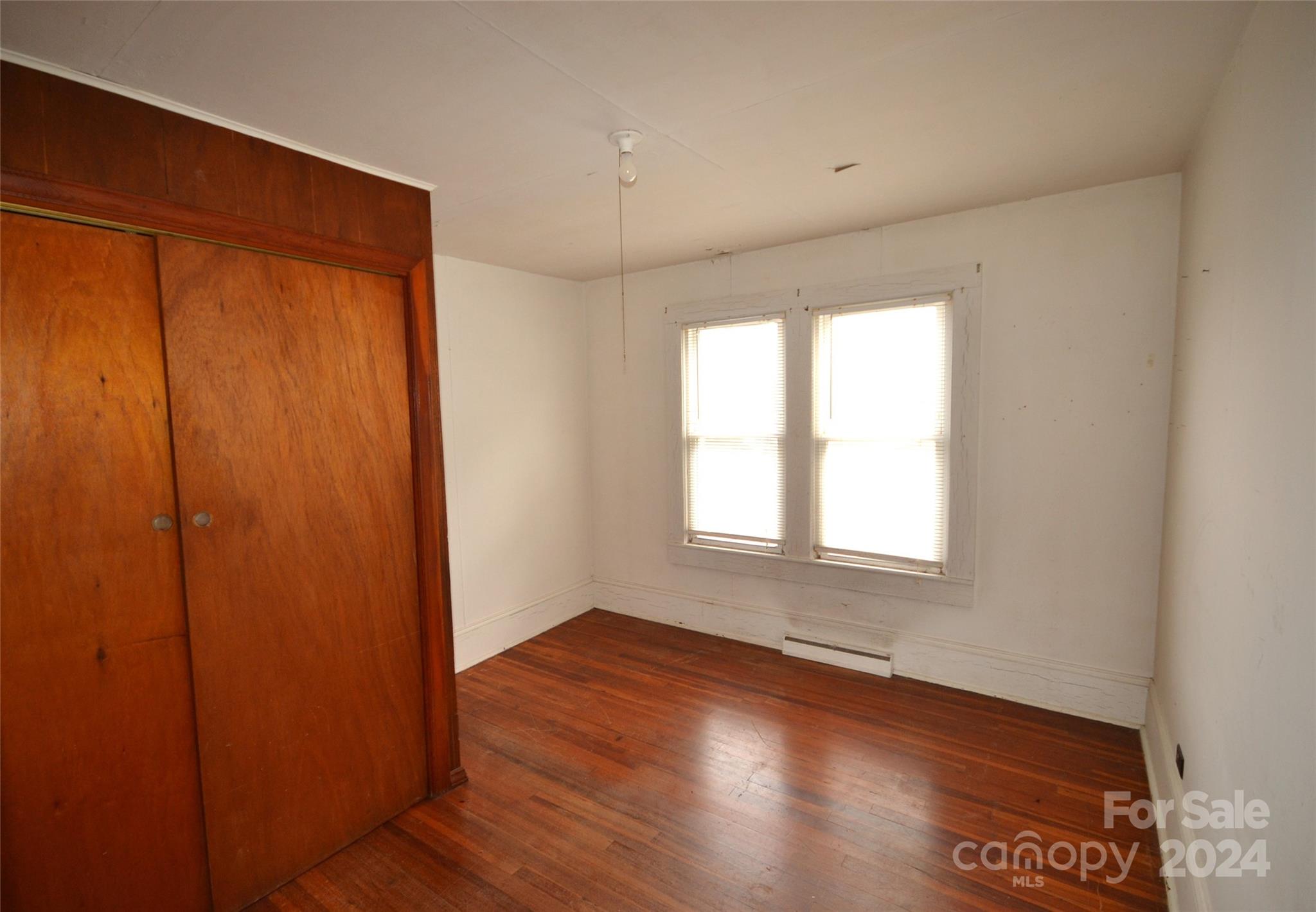 46 Murray Road Canton, NC 28716 - Photo 12 of 17 an empty room with wooden floor and windows