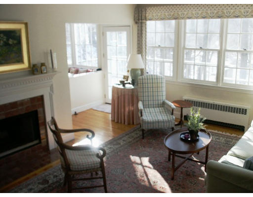 360 Woodland Road Brookline, MA 02467 - Photo 2 of 10 a living room with furniture a table and a fireplace