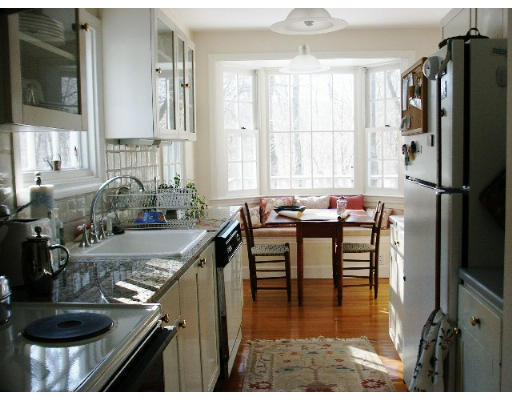 360 Woodland Road Brookline, MA 02467 - Photo 4 of 10 a kitchen with stainless steel appliances granite countertop a sink stove and refrigerator