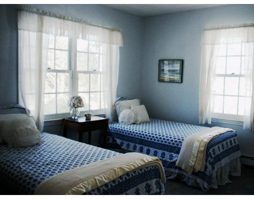 360 Woodland Road Brookline, MA 02467 - Photo 7 of 10 a bedroom with a bed and a window