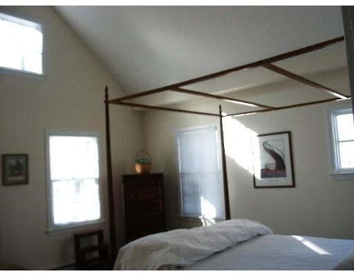 360 Woodland Road Brookline, MA 02467 - Photo 8 of 10 a bedroom with a bed and a window