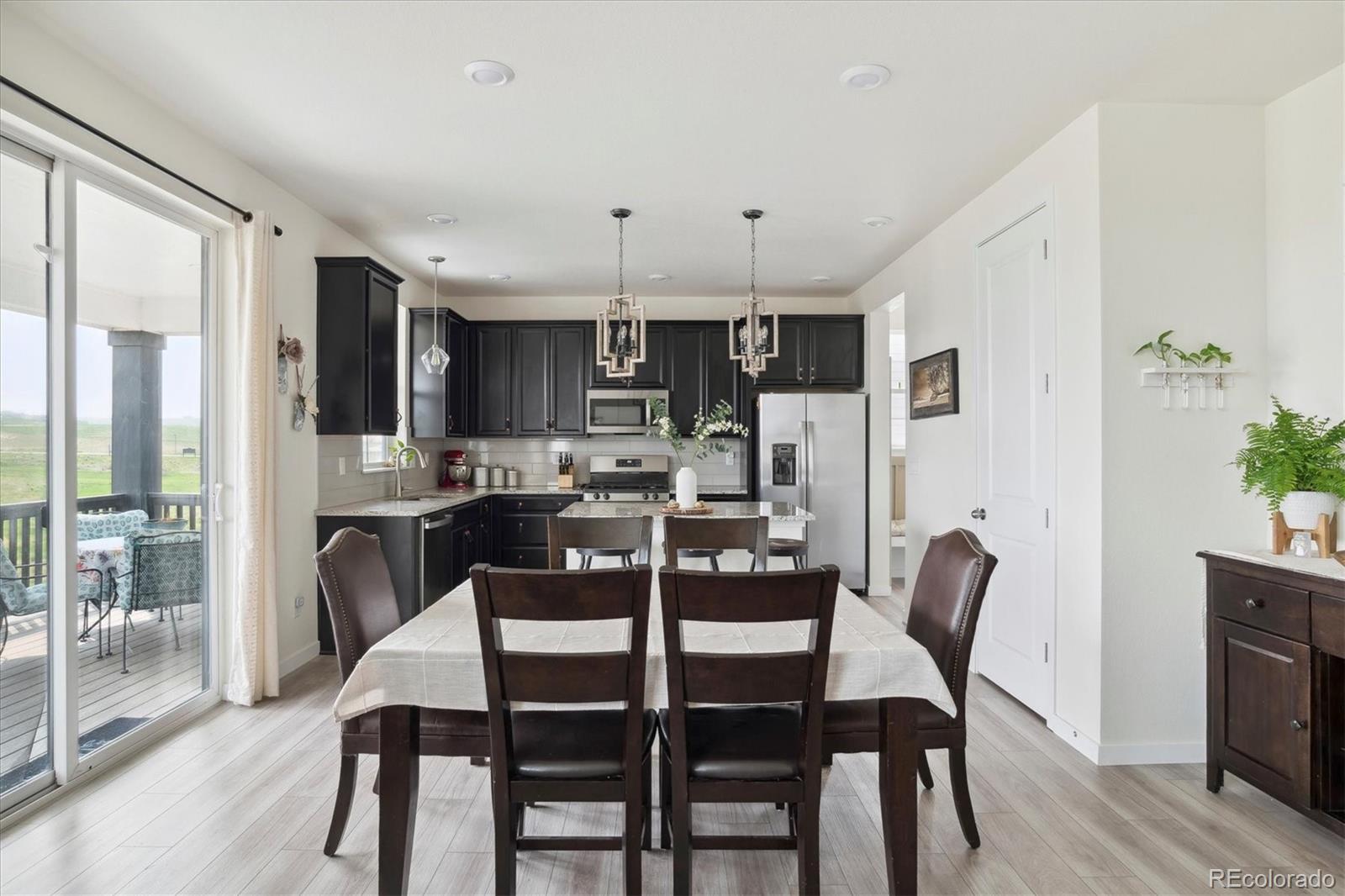1142 Williams Loop Elizabeth, CO 80107 - Photo 13 of 38 a view of a dining room with furniture and wooden floor
