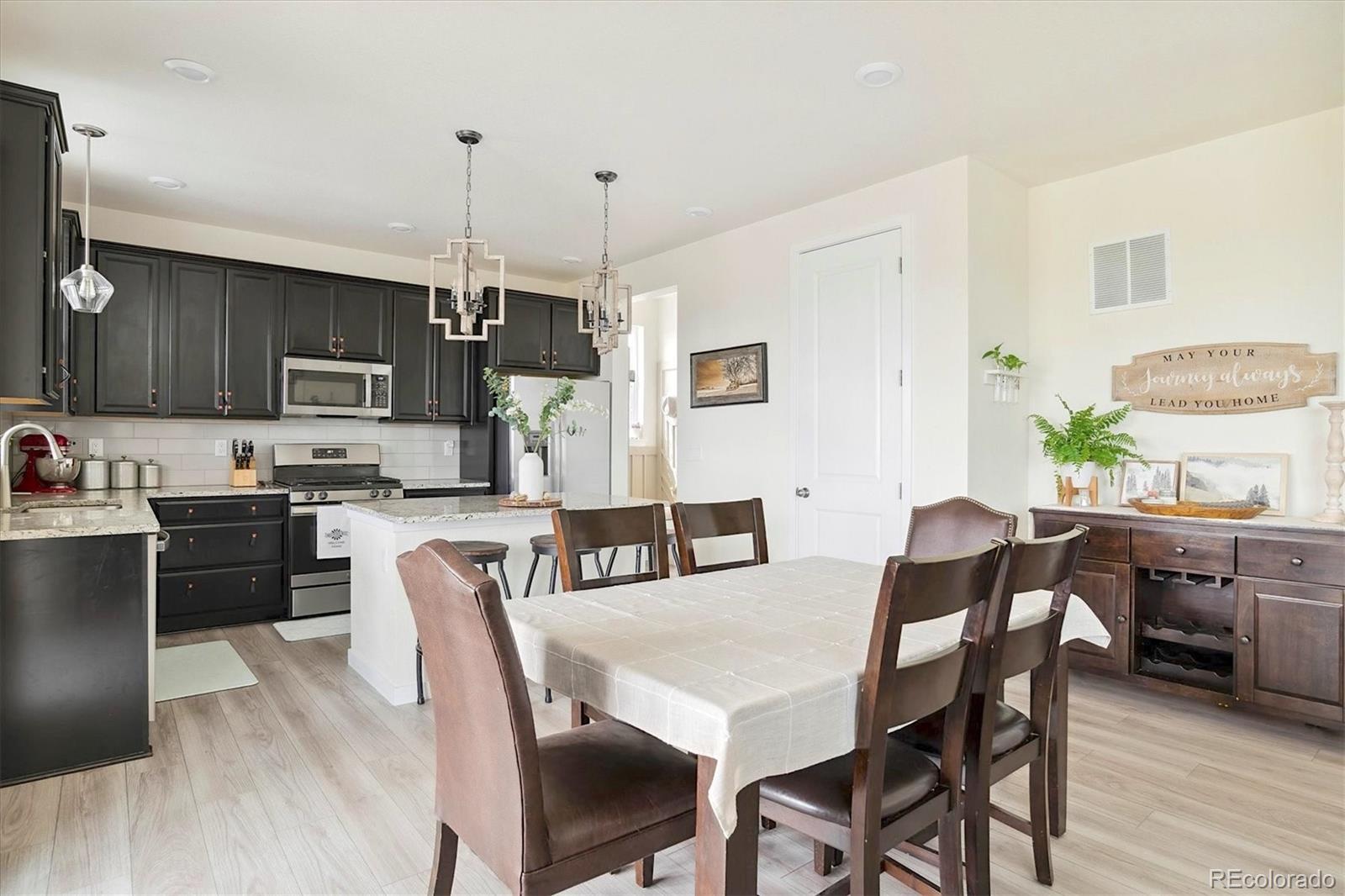 1142 Williams Loop Elizabeth, CO 80107 - Photo 14 of 38 a view of kitchen with granite countertop microwave cabinets dining table and chairs