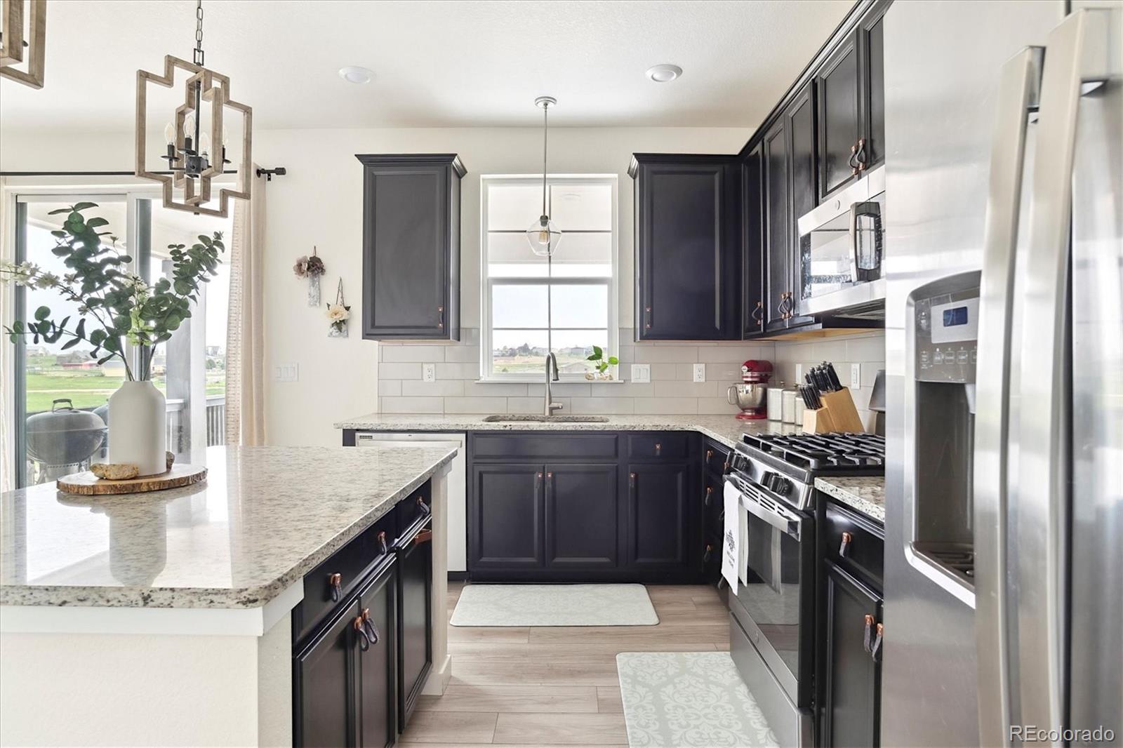 1142 Williams Loop Elizabeth, CO 80107 - Photo 17 of 38 a kitchen with stainless steel appliances granite countertop a sink stove and refrigerator