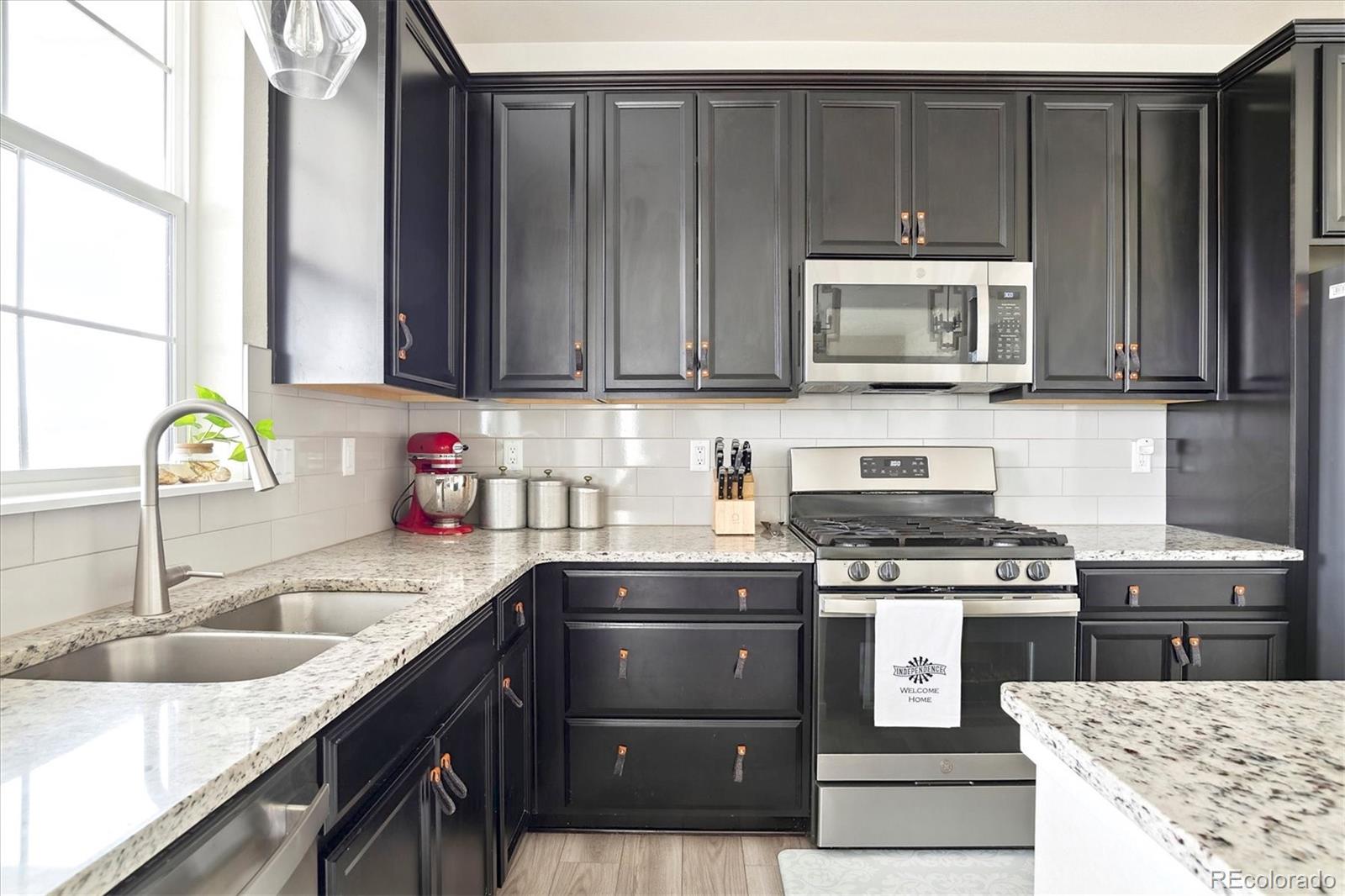 1142 Williams Loop Elizabeth, CO 80107 - Photo 18 of 38 a kitchen with a sink a stove and cabinets