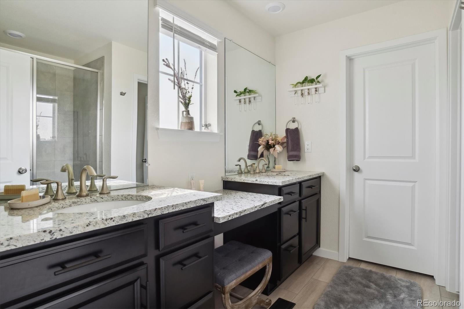 1142 Williams Loop Elizabeth, CO 80107 - Photo 22 of 38 a bathroom with a granite countertop sink and a mirror