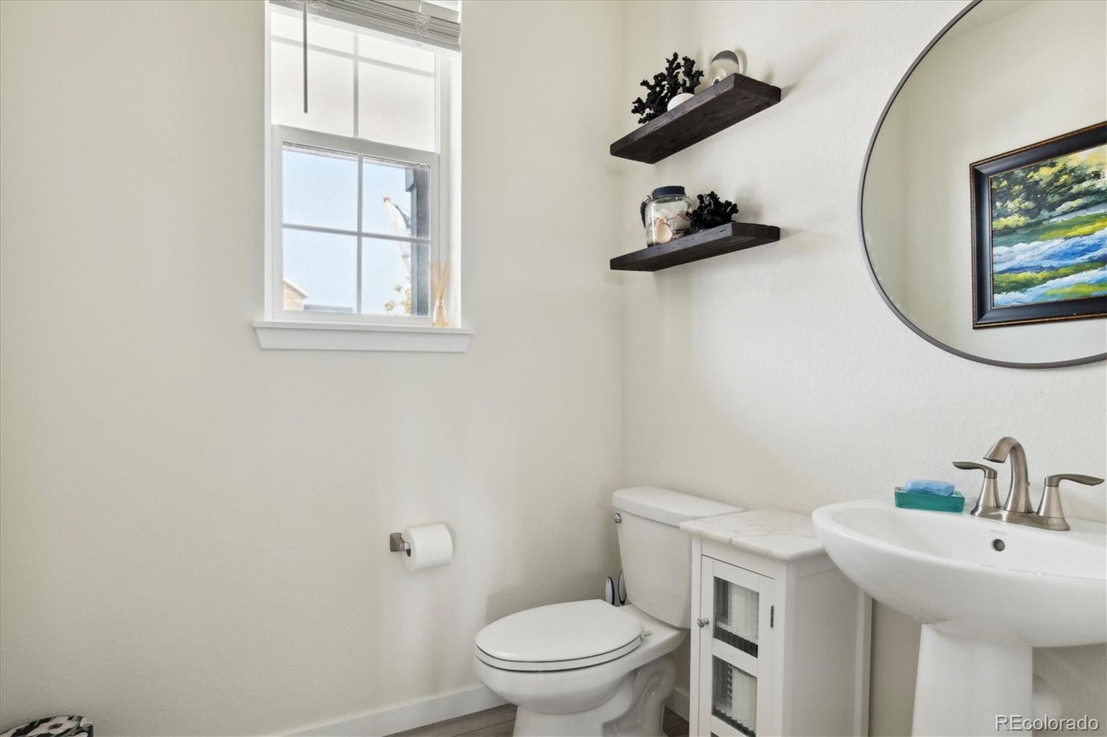 1142 Williams Loop Elizabeth, CO 80107 - Photo 27 of 38 a bathroom with a sink mirror and toilet